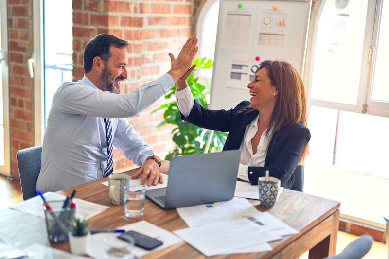 Two executives celebrating a successful senior appointment
