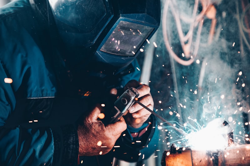 Skilled general worker welding on a production floor